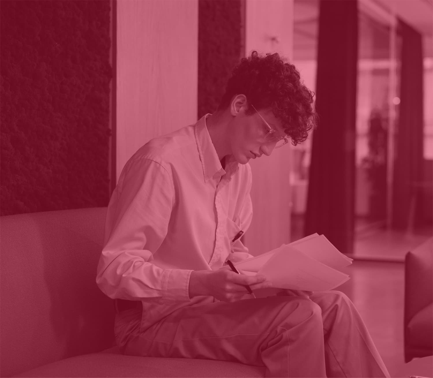young man reading papers